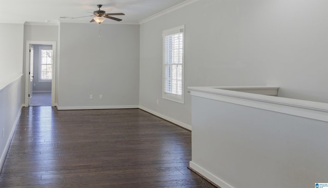 empty room featuring dark hardwood / wood-style floors, a healthy amount of sunlight, ornamental molding, and ceiling fan