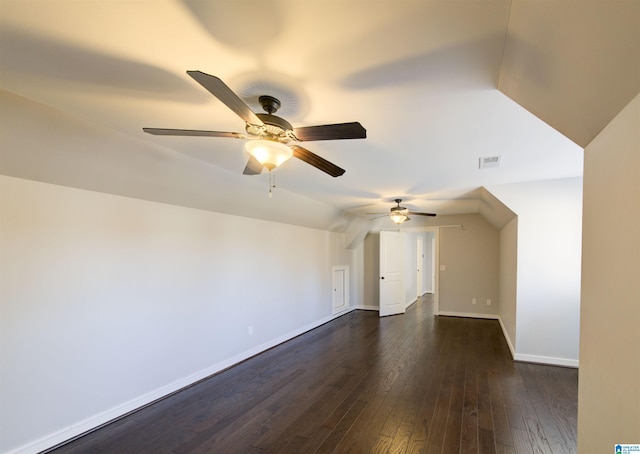 interior space featuring dark hardwood / wood-style floors, vaulted ceiling, and ceiling fan