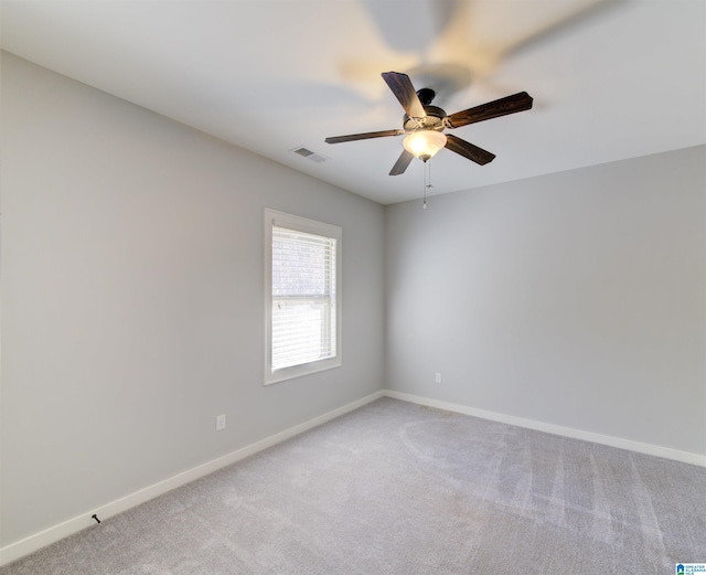 empty room featuring ceiling fan and light colored carpet