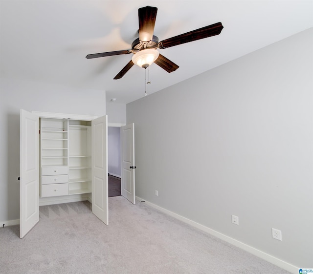 unfurnished bedroom with ceiling fan, a closet, and light colored carpet