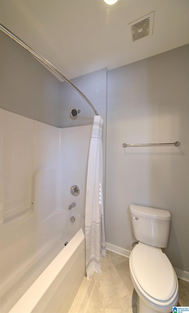 bathroom with tile patterned flooring, toilet, and shower / tub combo