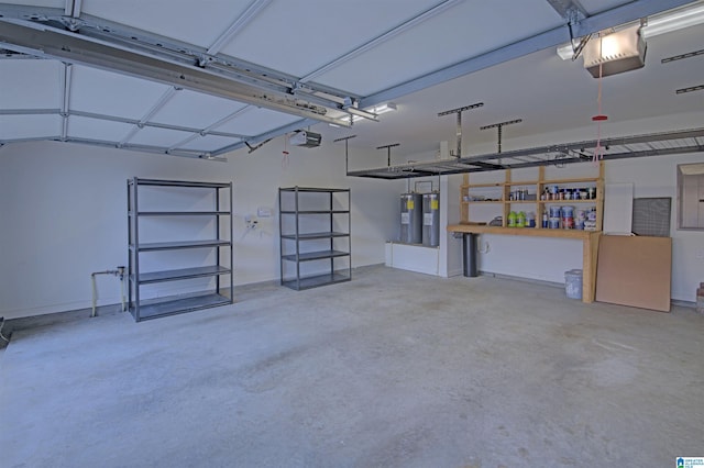 garage featuring water heater and a garage door opener