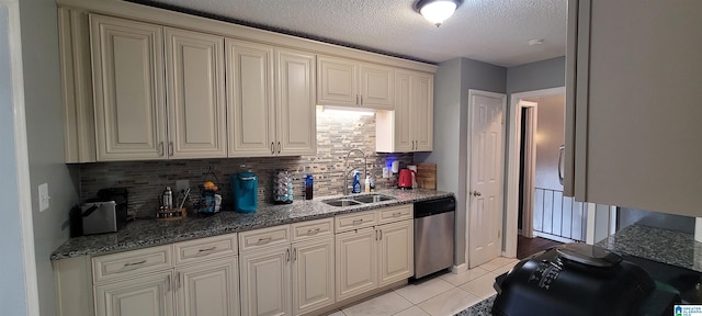 kitchen featuring stainless steel dishwasher, light tile patterned floors, sink, and tasteful backsplash