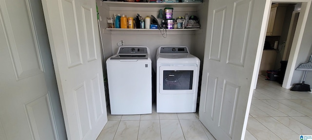 clothes washing area with washing machine and clothes dryer