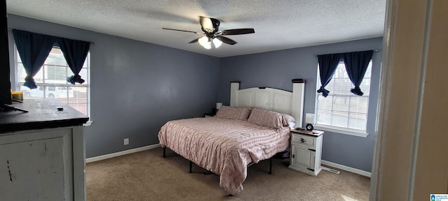 carpeted bedroom with a textured ceiling and ceiling fan