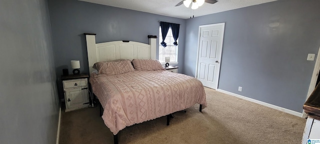 carpeted bedroom with ceiling fan and a textured ceiling