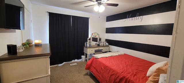 carpeted bedroom featuring ceiling fan and a textured ceiling