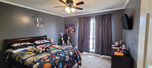 carpeted bedroom with ceiling fan, a textured ceiling, and ornamental molding