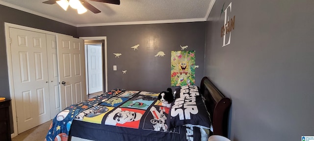 carpeted bedroom featuring a textured ceiling, ceiling fan, ornamental molding, and a closet