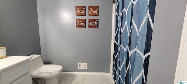 bathroom featuring toilet and vanity