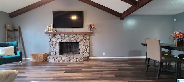 dining area with vaulted ceiling with beams, dark hardwood / wood-style floors, and a fireplace