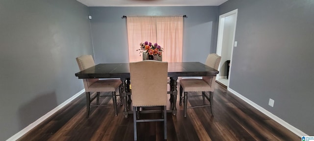 dining room with dark hardwood / wood-style flooring