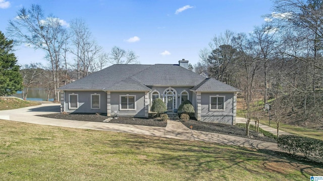 view of front facade with a water view, a trampoline, and a front yard