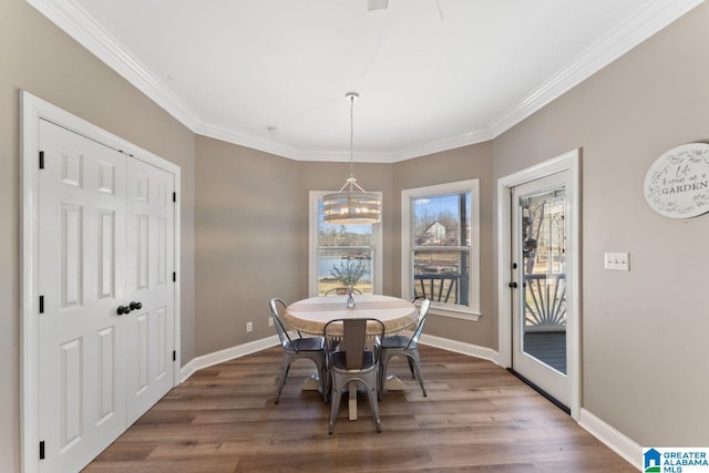 dining area with hardwood / wood-style floors and crown molding