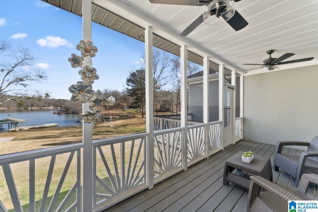 wooden deck featuring a water view and ceiling fan