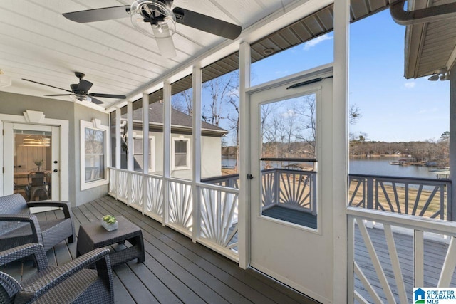 sunroom / solarium featuring a water view and ceiling fan