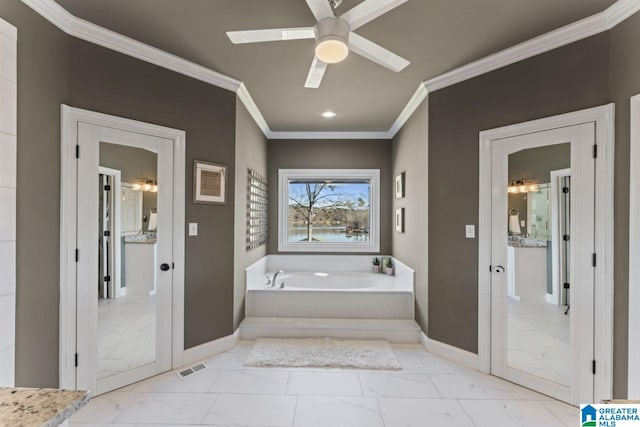 bathroom with ceiling fan, crown molding, and a tub to relax in