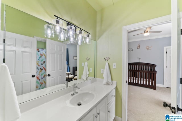 bathroom with ceiling fan, crown molding, and vanity