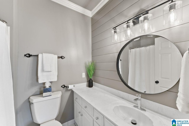 bathroom with vanity, toilet, and ornamental molding