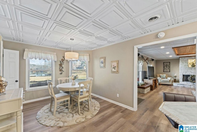 dining room featuring a fireplace and hardwood / wood-style floors