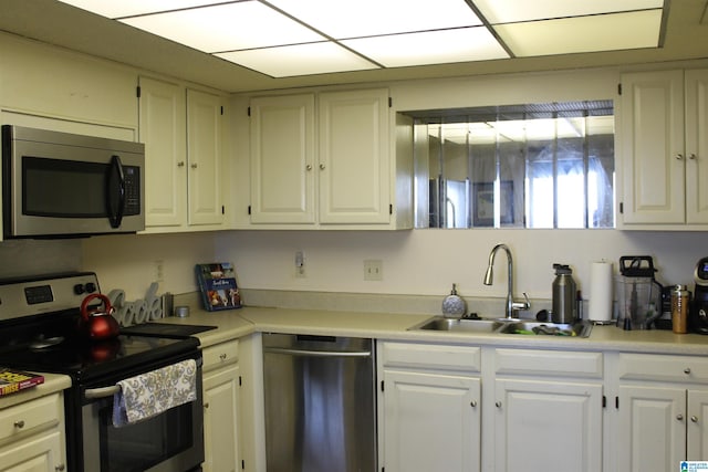 kitchen featuring white cabinetry, sink, and appliances with stainless steel finishes