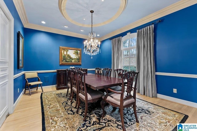 dining space featuring a chandelier, light hardwood / wood-style floors, and ornamental molding