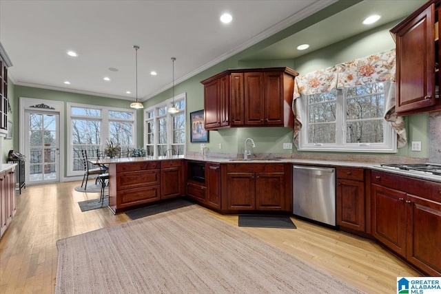 kitchen featuring pendant lighting, light hardwood / wood-style floors, crown molding, and appliances with stainless steel finishes