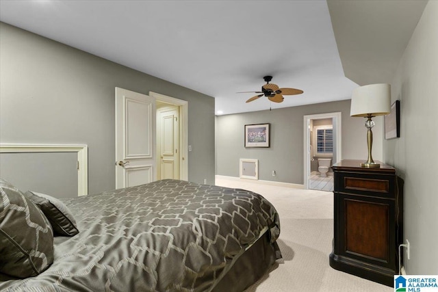 carpeted bedroom with ceiling fan and ensuite bathroom