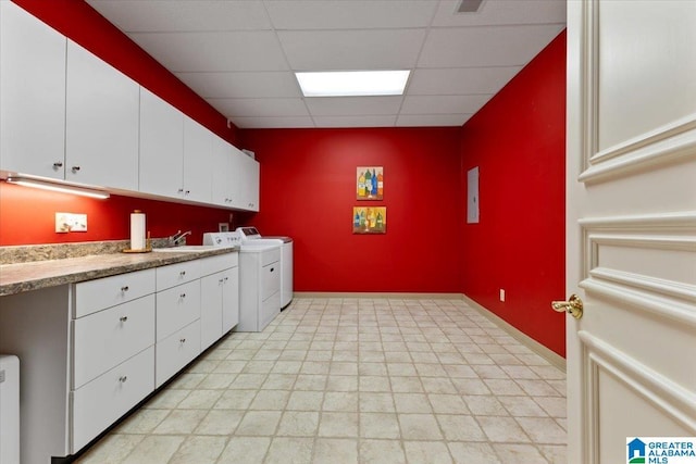 washroom featuring washing machine and clothes dryer, sink, cabinets, and radiator heating unit