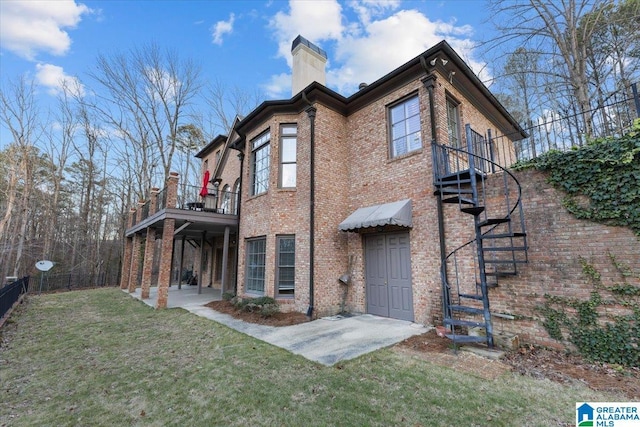 rear view of property featuring a lawn and a patio area