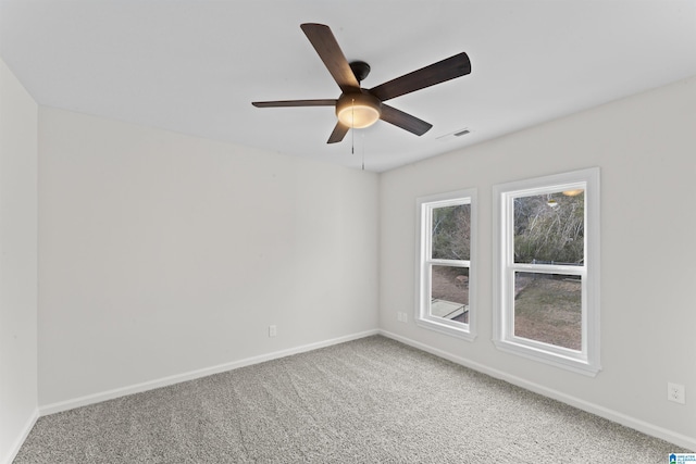 spare room featuring ceiling fan and carpet flooring