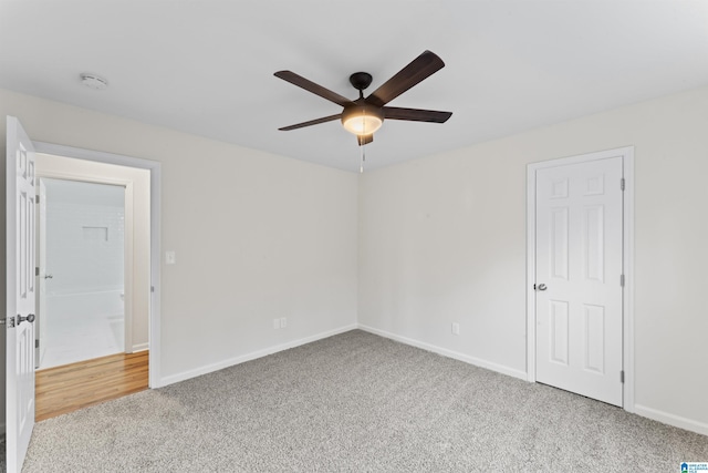 spare room featuring light carpet and ceiling fan