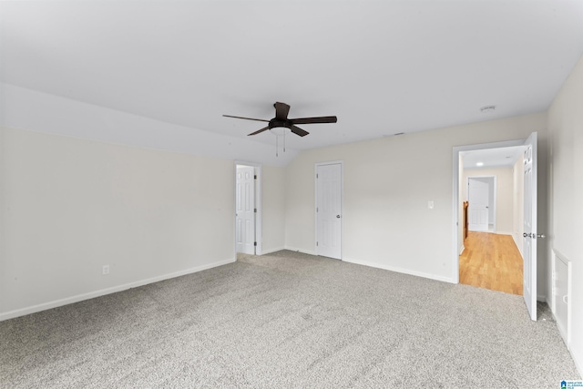 unfurnished bedroom with carpet floors, ceiling fan, and vaulted ceiling