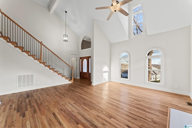 foyer entrance featuring a high ceiling and hardwood / wood-style flooring