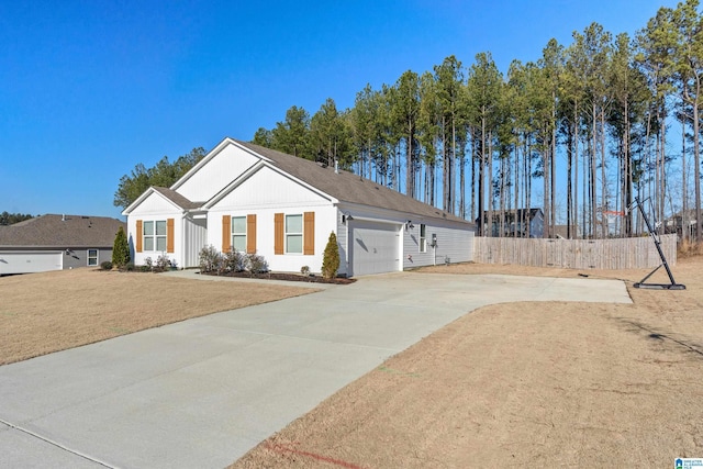 view of front of house featuring a garage and a front lawn