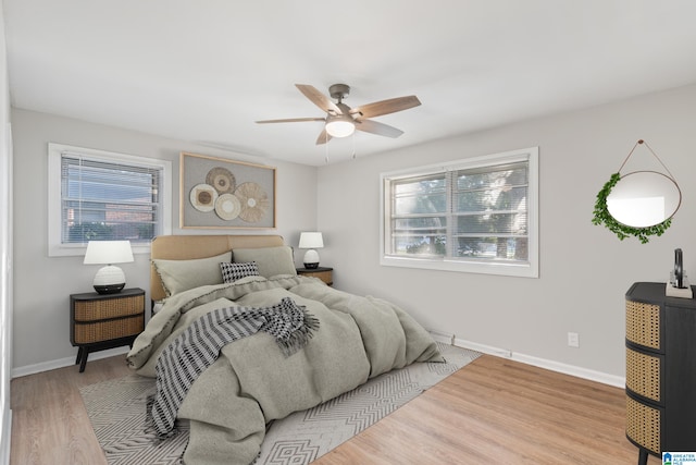 bedroom with ceiling fan and light hardwood / wood-style floors