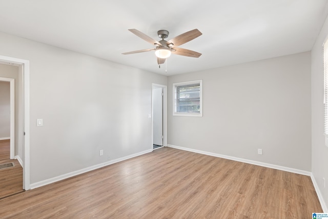 spare room with ceiling fan and light wood-type flooring