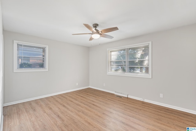 empty room featuring ceiling fan and light wood-type flooring