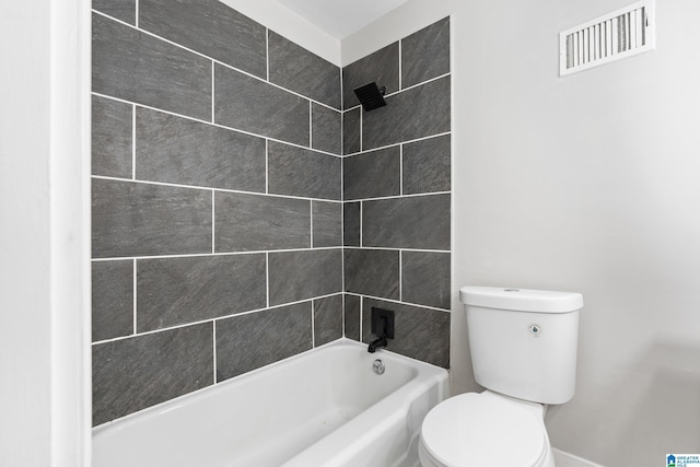 bathroom featuring toilet and tiled shower / bath