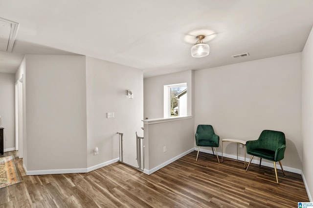 sitting room featuring dark wood-type flooring