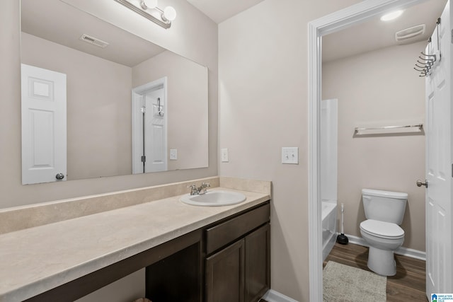 full bathroom featuring wood-type flooring, vanity, toilet, and shower / tub combination