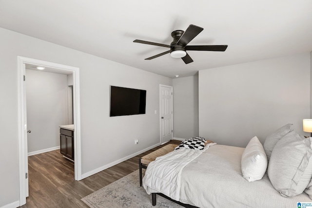 bedroom featuring ceiling fan, ensuite bathroom, and dark hardwood / wood-style floors