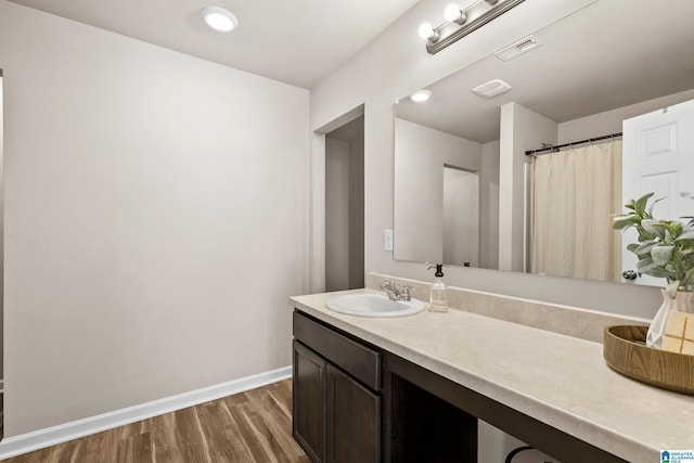 bathroom with hardwood / wood-style floors and vanity