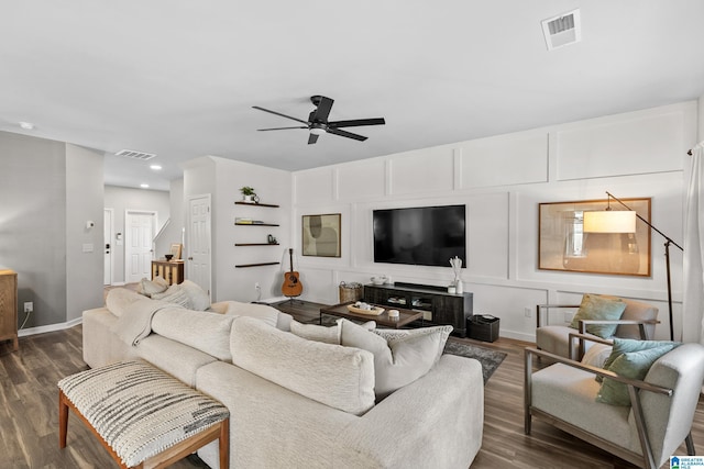 living room featuring dark hardwood / wood-style flooring and ceiling fan