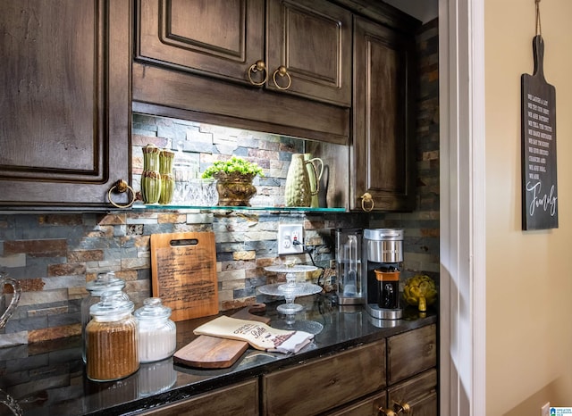 bar with tasteful backsplash, dark stone countertops, and dark brown cabinets