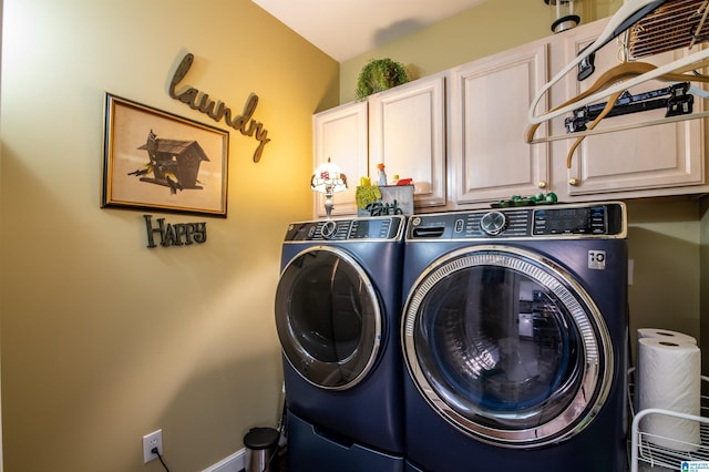 washroom featuring washing machine and dryer and cabinets