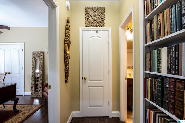 corridor with dark hardwood / wood-style flooring