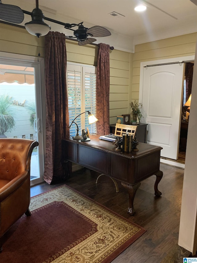 home office with wood walls, dark hardwood / wood-style floors, and ceiling fan