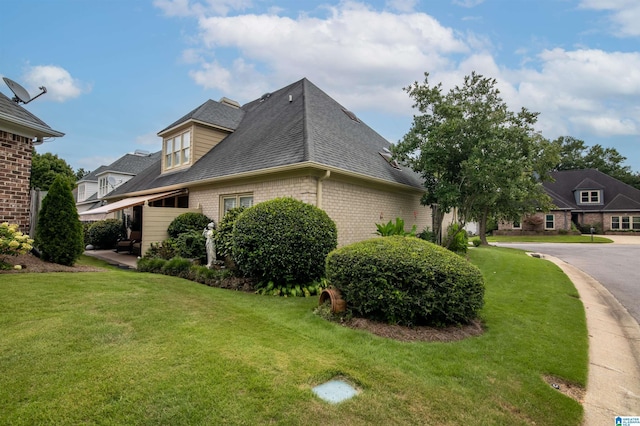 view of side of home with a lawn