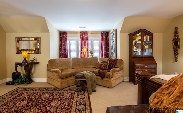 carpeted living room with lofted ceiling